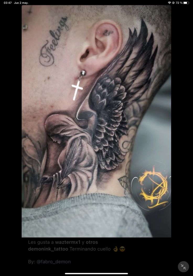 a man with a cross and wings tattoo on his neck