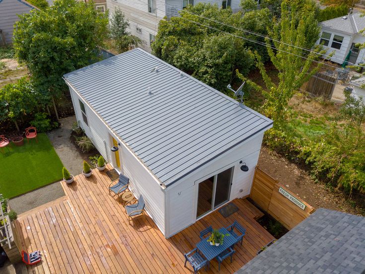 an aerial view of a house with a deck and patio in the back yard area