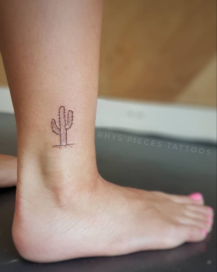 a small cactus tattoo on the ankle