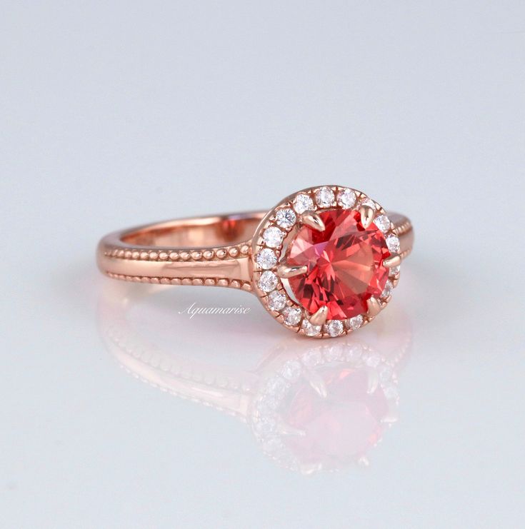 Gorgeous Vintage Inspired Orange Sapphire Ring ►Made of solid sterling silver with 14k rose gold finish (925) ►Accented With Simulated Diamonds (CZ) ►Average band width: 2.5 mm Center Stone: Sapphire Color: Orange Shape: Round Measurements: 6.5 mm Carat Weight: 1.4 ct. (approx.) Gemstone creation: 100% Genuine Lab-Grown Sapphire Hardness: 9-9.5 (Mohs scale) ►Please be aware that plated jewelry can wear off over time, if this is a concern we would suggest going with the sterling silver or solid g Classic Pink Cluster Ring For Anniversary, Classic Pink Halo Ring, Classic 14k Rose Gold Rings With Accent Stones, Classic Rose Gold Rings With Accent Stones, Classic Ruby Ring With Halo Setting For Promise, 14k Rose Gold Halo Promise Ring, Rose Gold Cluster Ring With Round Band For Anniversary, Rose Gold Round Band Birthstone Anniversary Ring, Classic Halo Ruby Promise Ring