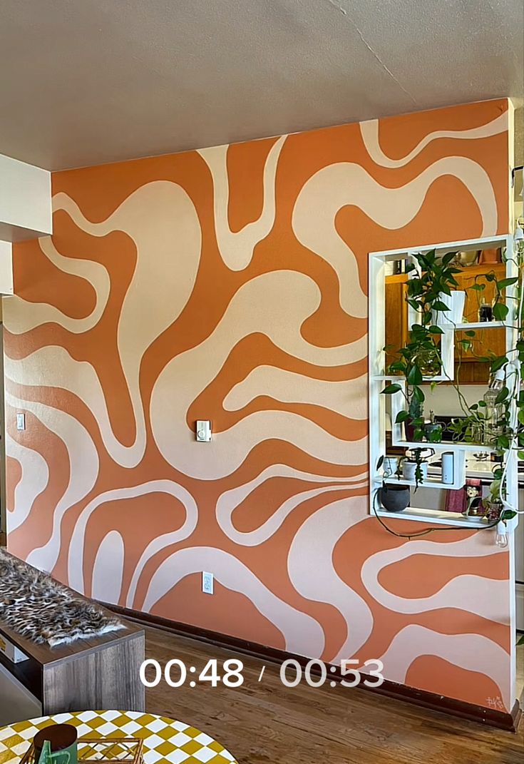 an orange and white wall in a living room with a mirror on the wall next to it