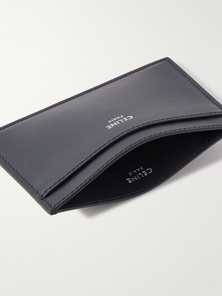 Use CELINE HOMME's sleek cardholder to keep your most-used credentials organised. Made in Italy from leather with a subtle grain, it has a single slot on each side and a central compartment for bills and receipts. A silver designer emblem is stamped on the front. Modern Business Card Holder With Card Slots, Modern Leather Card Holder For Business, Modern Leather Business Card Holder, Luxury Wallets With Card Slots, Elegant Business Card Holder With Smooth Grain, Elegant Smooth Grain Card Holder For Business, Modern Formal Card Holder With Card Slots, Elegant Smooth Grain Leather Card Holder For Formal Use, Elegant Leather Card Holder