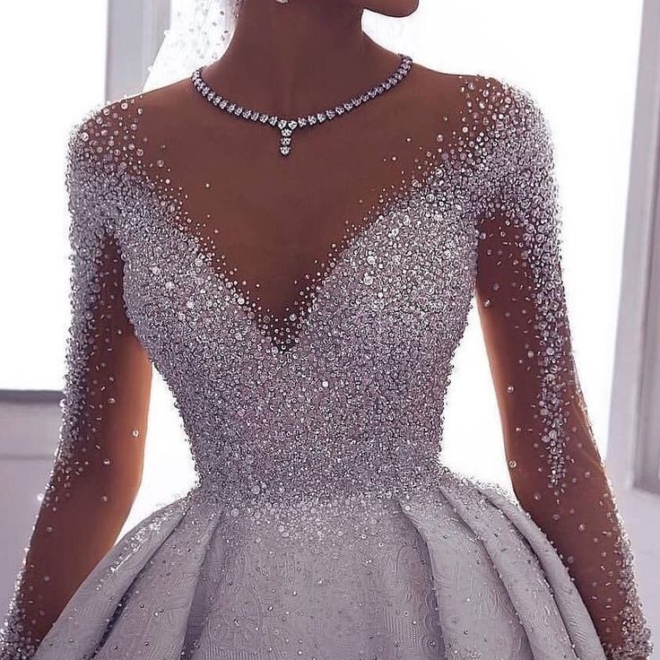 the back of a dress with pearls on it