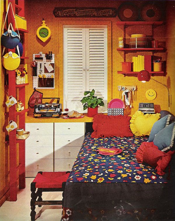 a bedroom with yellow walls and red furniture, including a bed in the center surrounded by bookshelves