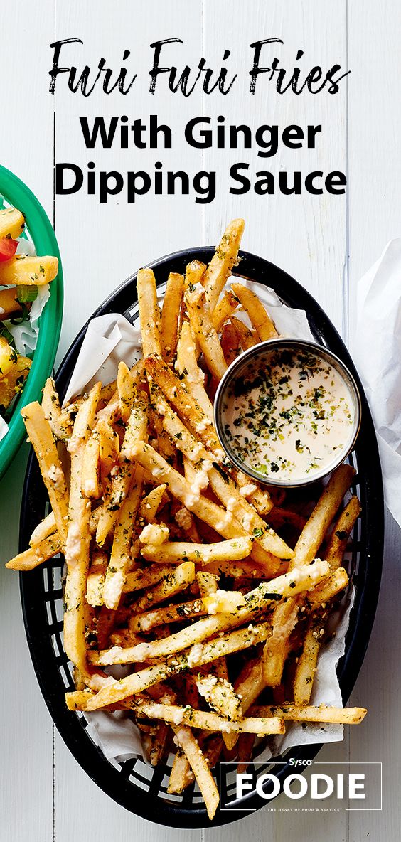 a plate with fries and a bowl of salad on the side