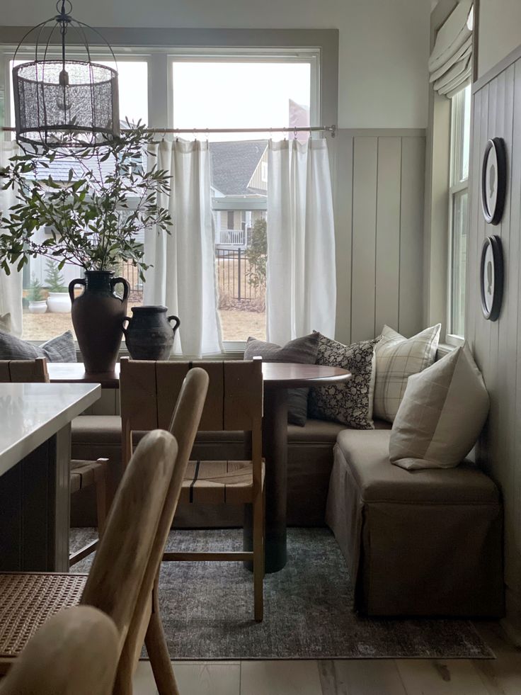 a living room filled with furniture and a potted plant on top of a table