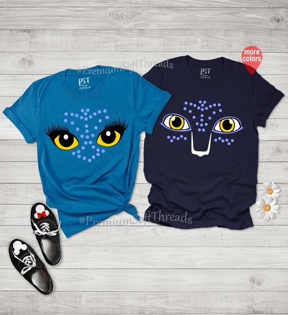 two t - shirts with yellow eyes on them, one is blue and the other is black