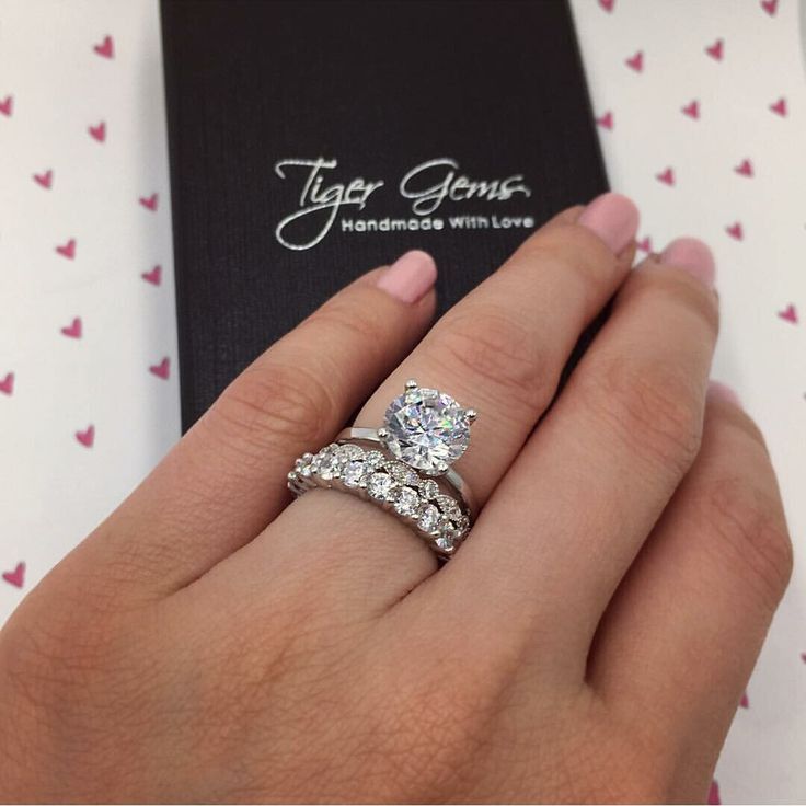 a close up of a person's hand with two rings