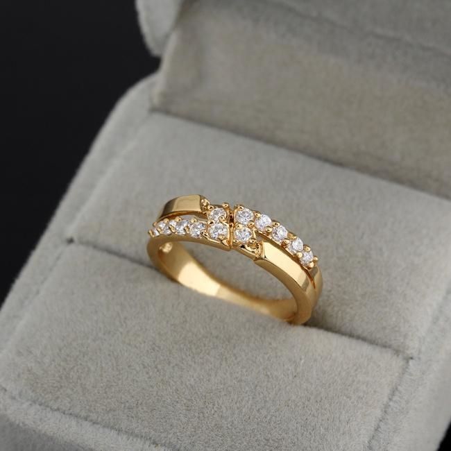 a gold ring with five diamonds in it