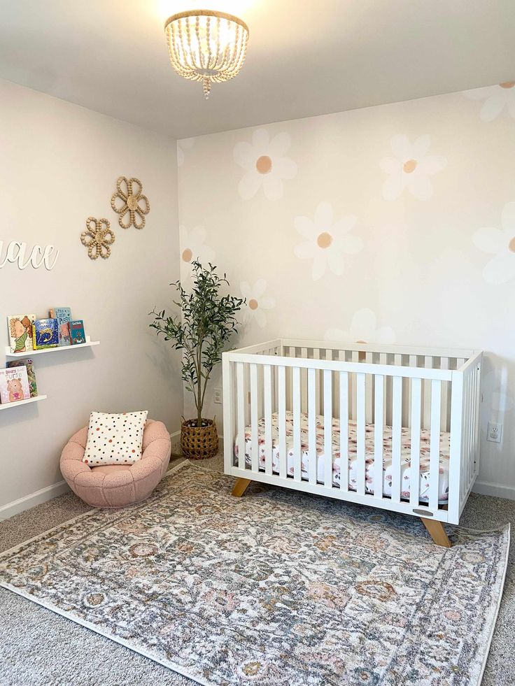 a baby's room with a crib, chair and rug