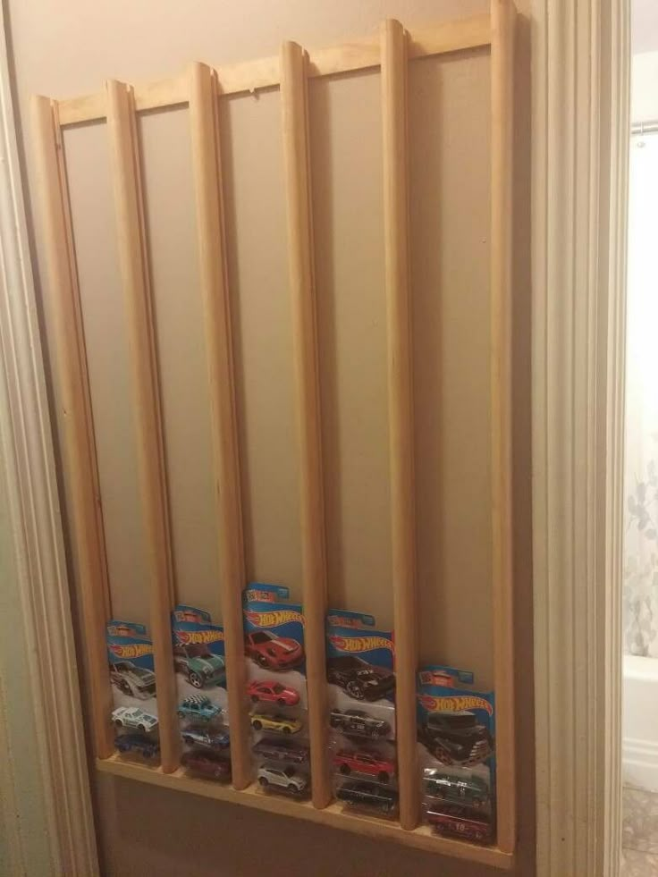 the toy cars are lined up on the shelf in the bathroom area, and ready to be put into the closet