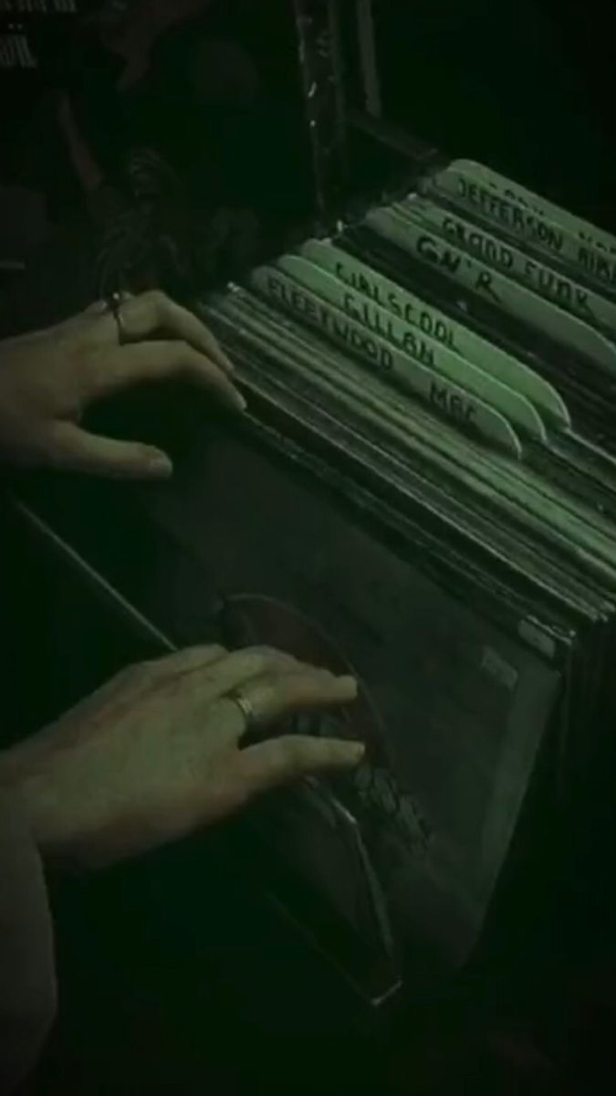 two hands reaching for records in an old typewriter