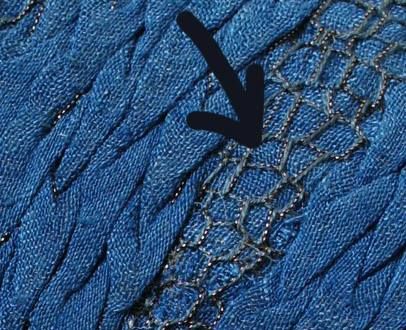 the stitchs on this blue fabric are very close to it's surface, and there is an arrow pointing up