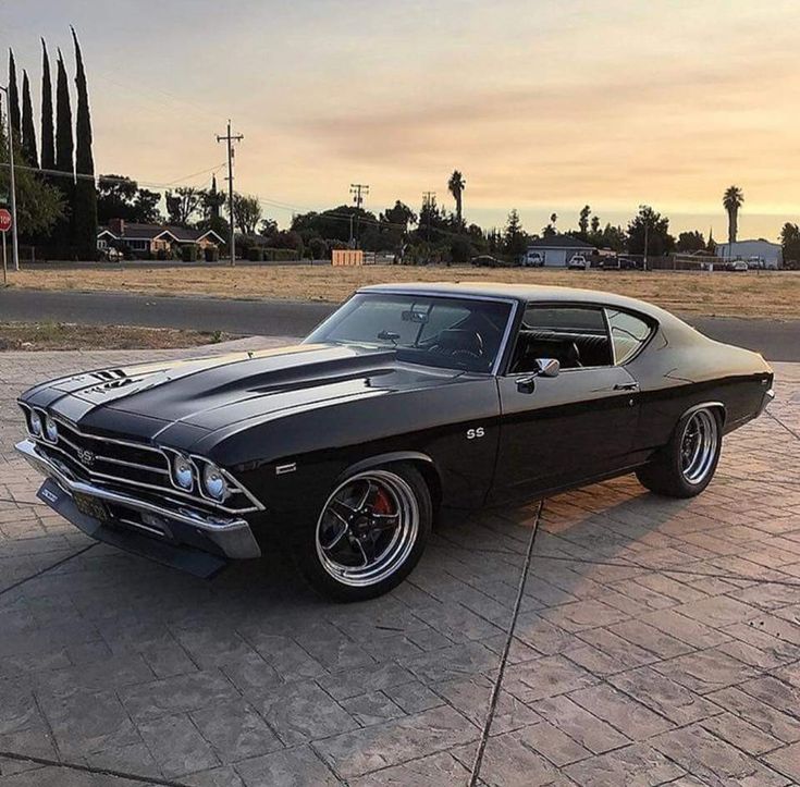 an old muscle car parked in a parking lot