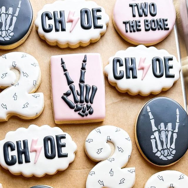 decorated cookies that say two the bone and one the hand