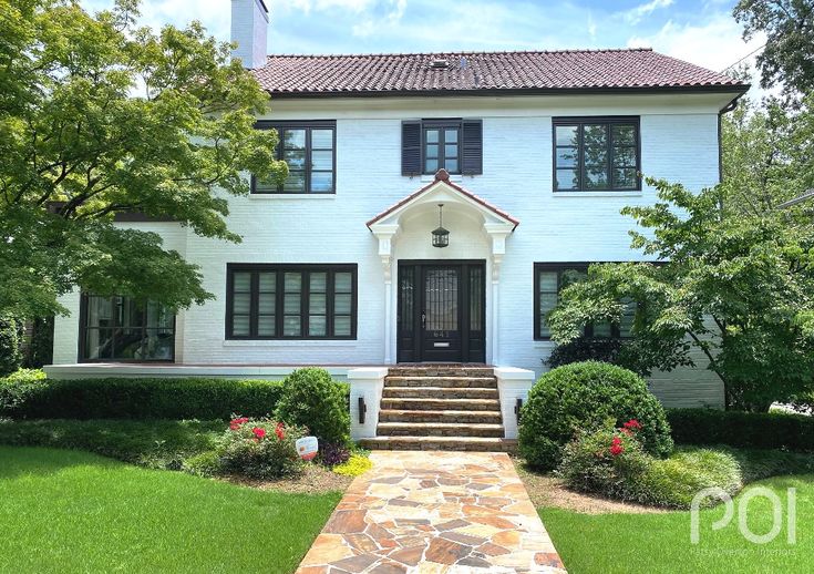 a white house with steps leading to the front door