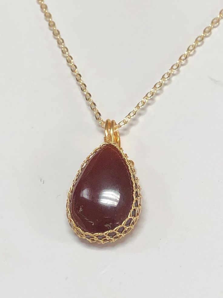 This listing is for one beautiful garnet necklace chosen at random. There may be slight variations in the stone/wire but they are all a good larger size and approximately the same. Comes with a chain like pictured Gold Wire-wrapped Drop Necklace As Gift, Gold Oval Garnet Necklaces, Gold Wire Wrapped Drop Necklace As Gift, Gold Wire-wrapped Drop Necklace For Gift, Elegant Oval Wire Wrapped Necklace, Gold Wire Wrapped Drop Necklace For Gift, Oval Garnet Gold Necklace, Elegant Carnelian Round Pendant Necklace, Garnet Gemstone Necklaces For Jewelry Making