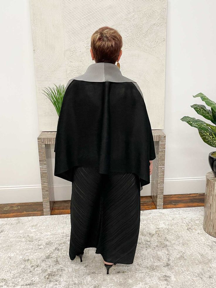 In mini pleats, this oversized kimono cover up has a sophisticated look in a trio of neutrals. The open front features two tones of grey while the back flatters in solid black. A wide fold over lapel frames the body, while the sewn sides create armholes. Fit fact: A generous one-size-fits-most works for sizes up to 3X Permanent pleat woven 100% Polyester Hand wash, dry flat Made in China Style # MB164 Oversized Kimono, China Style, Kimono Jacket, China Fashion, Fold Over, Front Open, Black Grey, Solid Black, Two Tone