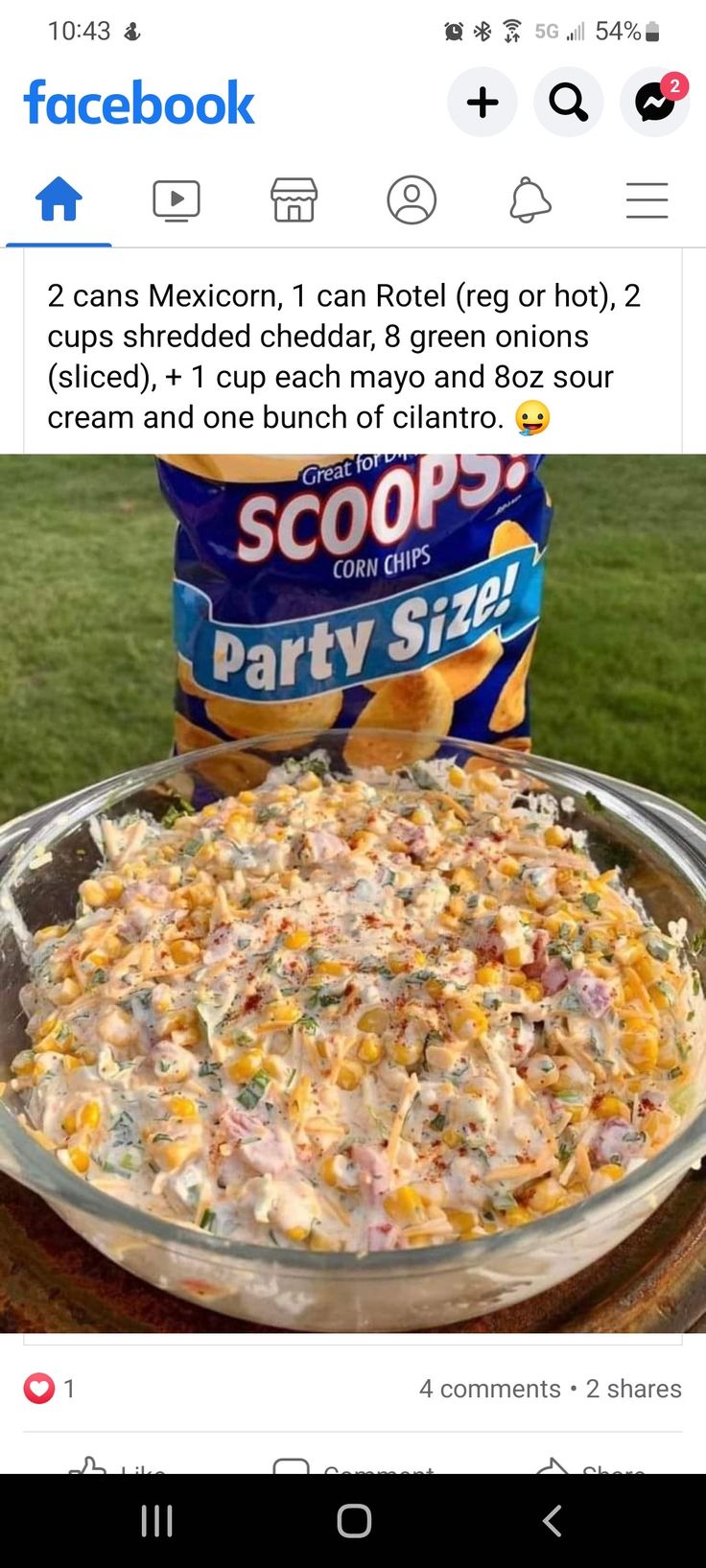 a bowl of food on top of a table next to a bag of chips and a can of soup