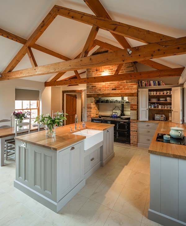 a kitchen with an island and wooden beams