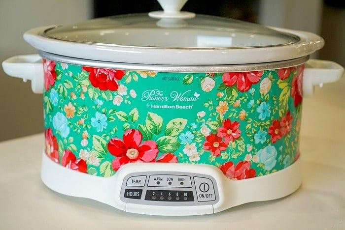 a colorful slow cooker sitting on top of a table