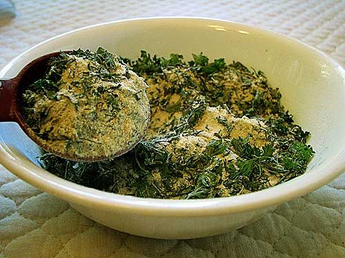 a white bowl filled with food on top of a table