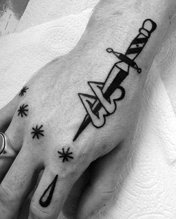 a black and white photo of a person's hand with a tattoo on it