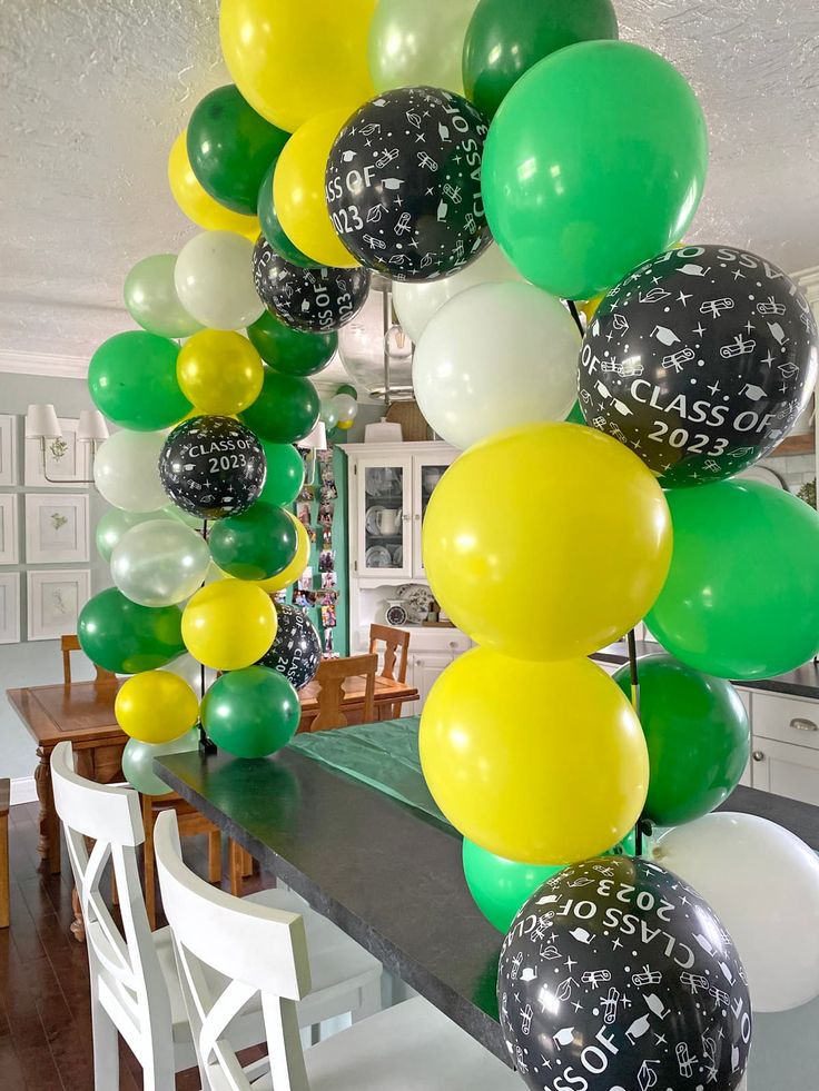 a table topped with lots of balloons filled with numbers