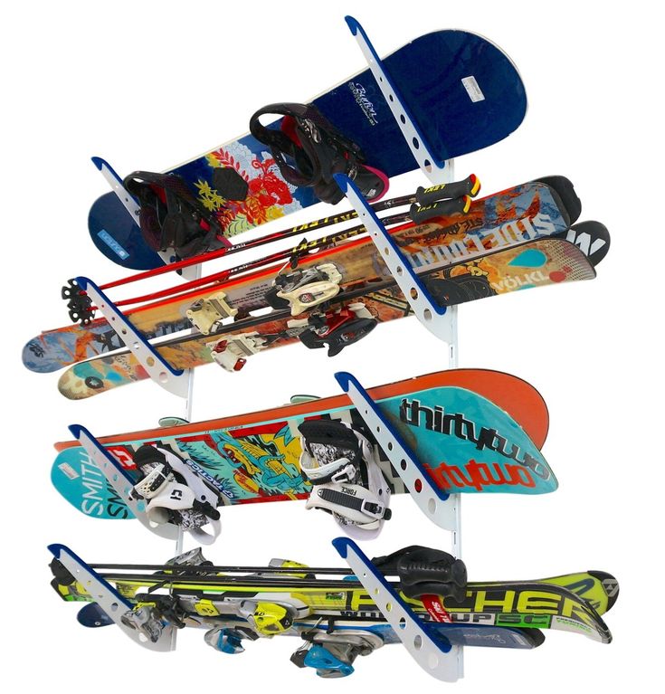 there are many snowboards and skis on the rack