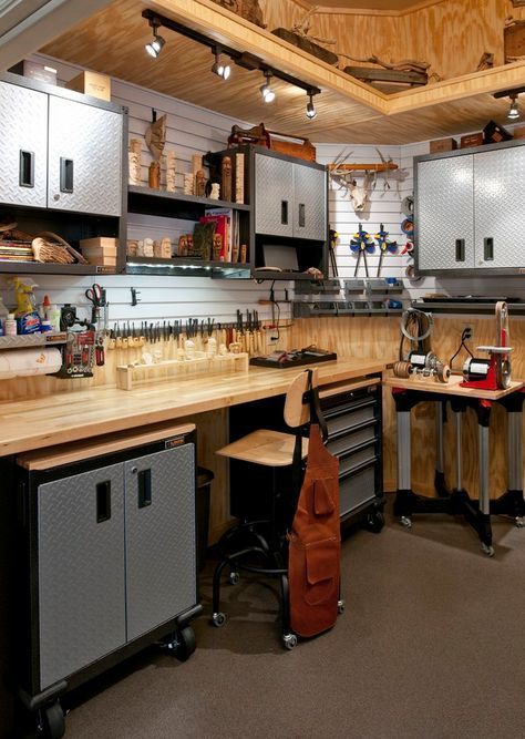 a workbench with lots of tools in it and some shelves on the wall