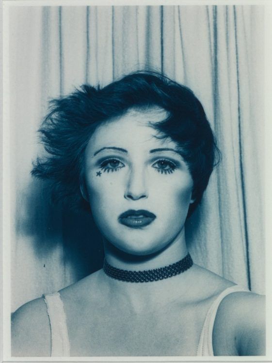 an old photo of a woman with makeup on her face