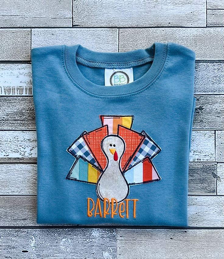 a blue shirt with a turkey on it