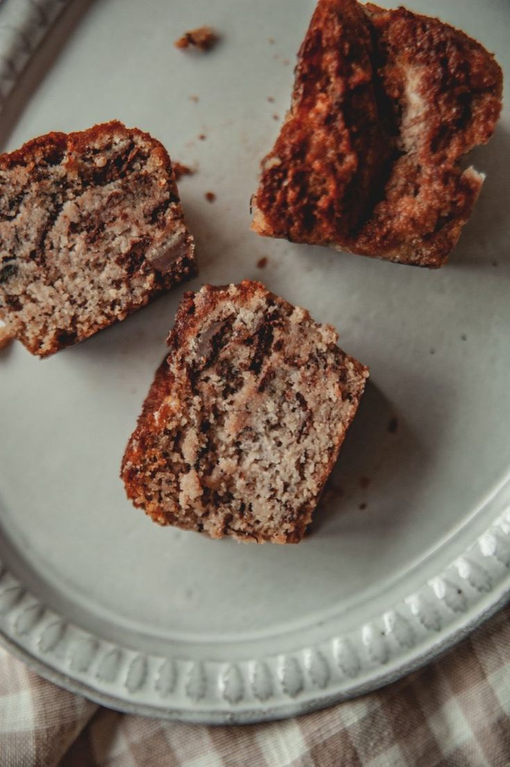 three muffins sitting on top of a white plate