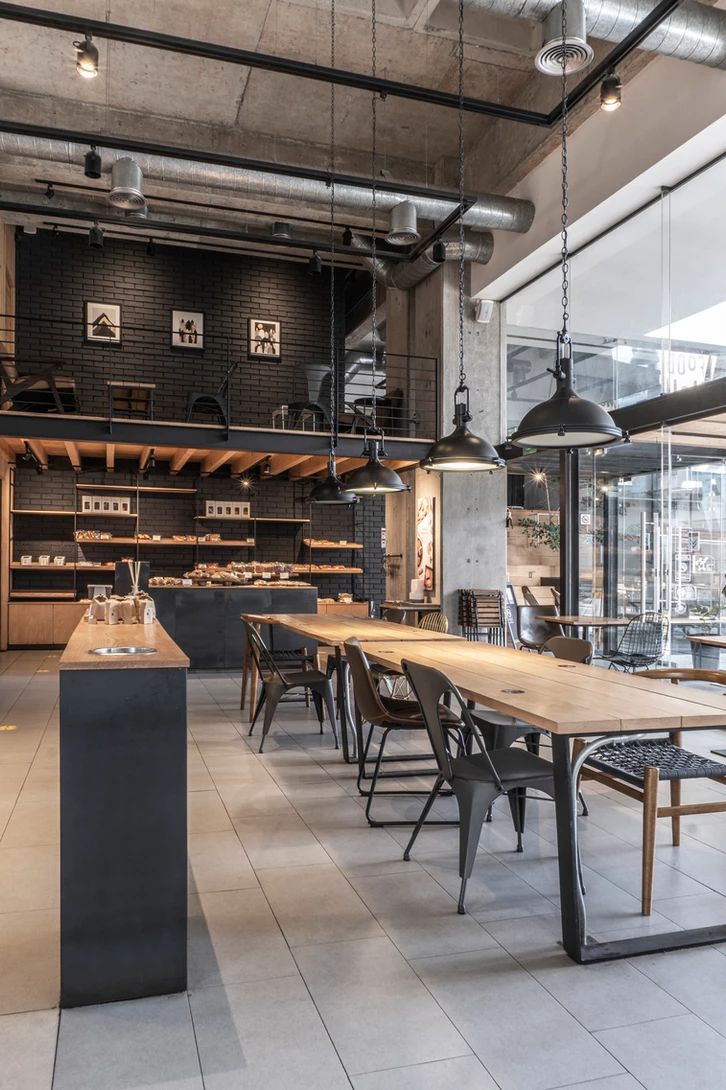 an empty restaurant with wooden tables and chairs