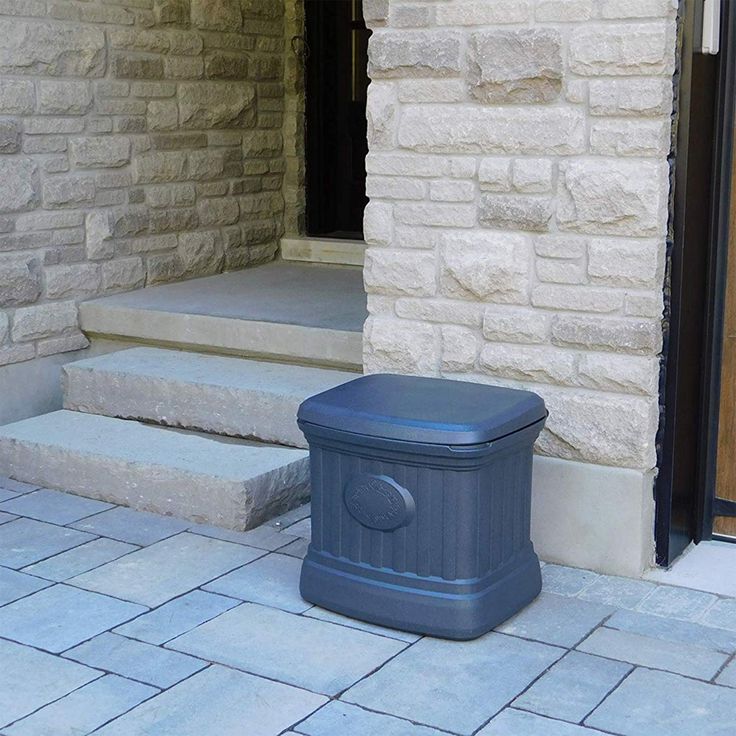 a blue trash can sitting in front of a door