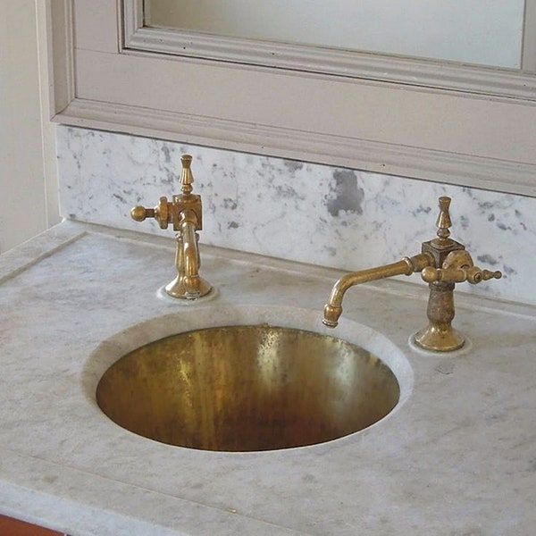 a bathroom sink with two faucets on it