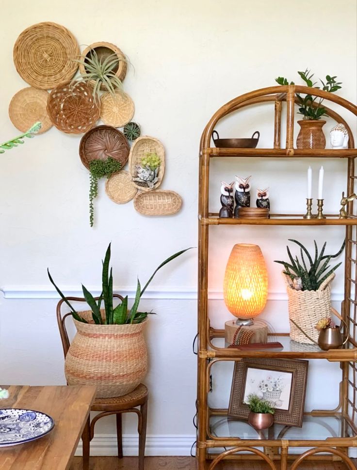 a living room filled with lots of plants and decor on top of a wooden table