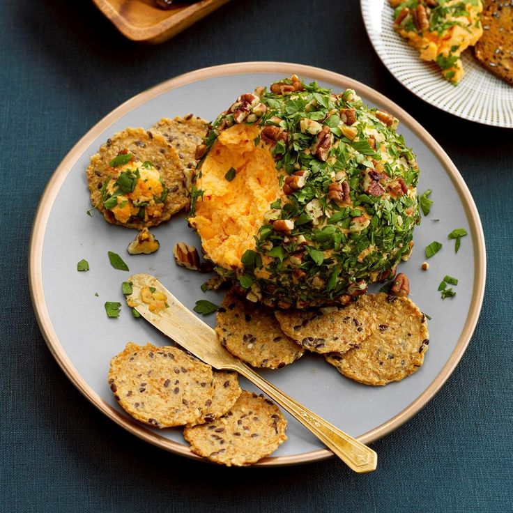 a white plate topped with food next to crackers