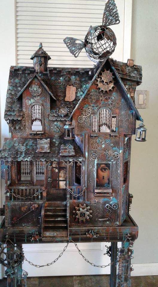 an old doll house with lots of decorations on the front and side of it's roof