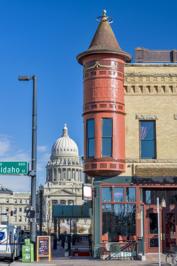 an old building with a dome on the top and a street sign in front of it