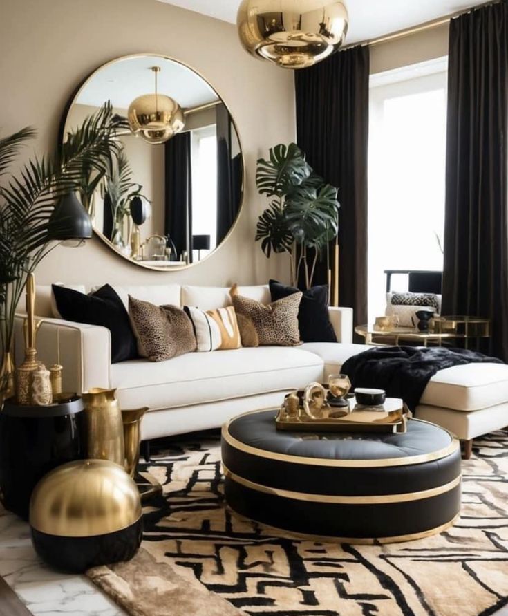 a living room with black and white furniture, gold accents and large mirrors on the wall