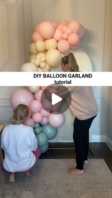 two women standing next to each other in front of balloons