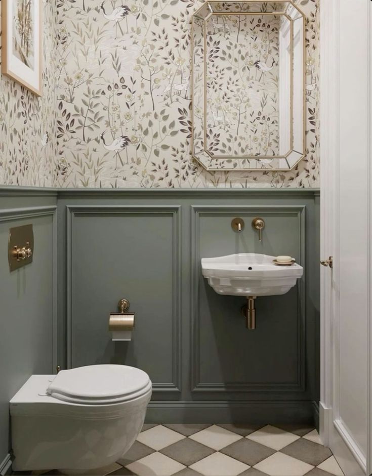 a white toilet sitting in a bathroom next to a wall mounted mirror and a sink