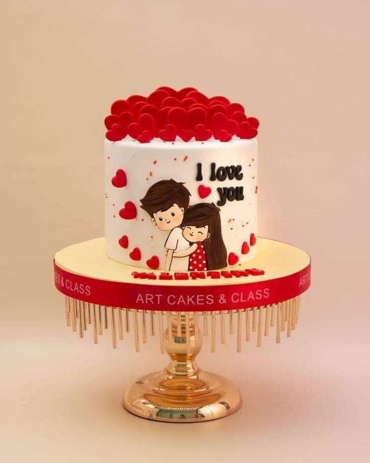 two tiered wedding cake with red roses on the top and i love you design