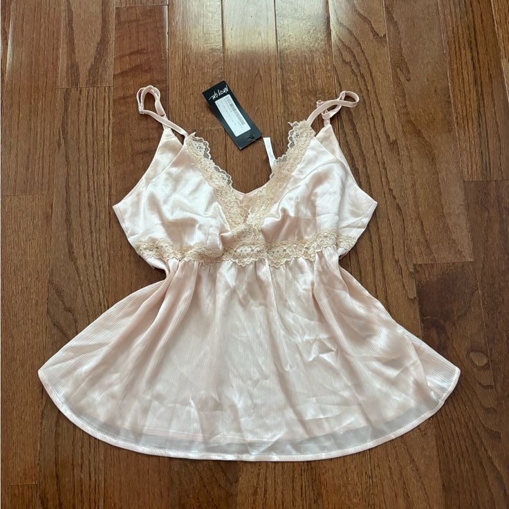 Nwt Nasty Gal Cream Colored Trim The Lights Satin Cami Top Out Of Stock Online! Brand: Nasty Gal In The Mood. This Cami Top Comes In Satin And Features A Relaxed Silhouette, V-Neckline With Lace Trim, Crochet Detailing Under Bust, And Adjustable Straps. It’s Super Soft And Very Cute And Flattering On Feminine Lace Tops For Sleep, Feminine Lace Sleep Tops, Sleeveless Top For Spring Wedding, Cami Top For Wedding Night In Summer, Sleeveless Tops For Wedding Night In Spring, Feminine Tops For Wedding Night In Spring, Summer Wedding Night Cami Top, Feminine Spring Wedding Night Tops, Feminine Sleeveless Tops For Wedding Night