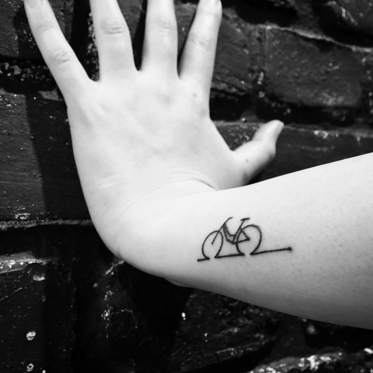 a person's arm with a tattoo on it and a bike in the middle