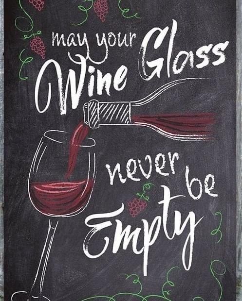 a chalkboard sign that says, may your wine glass never be empty