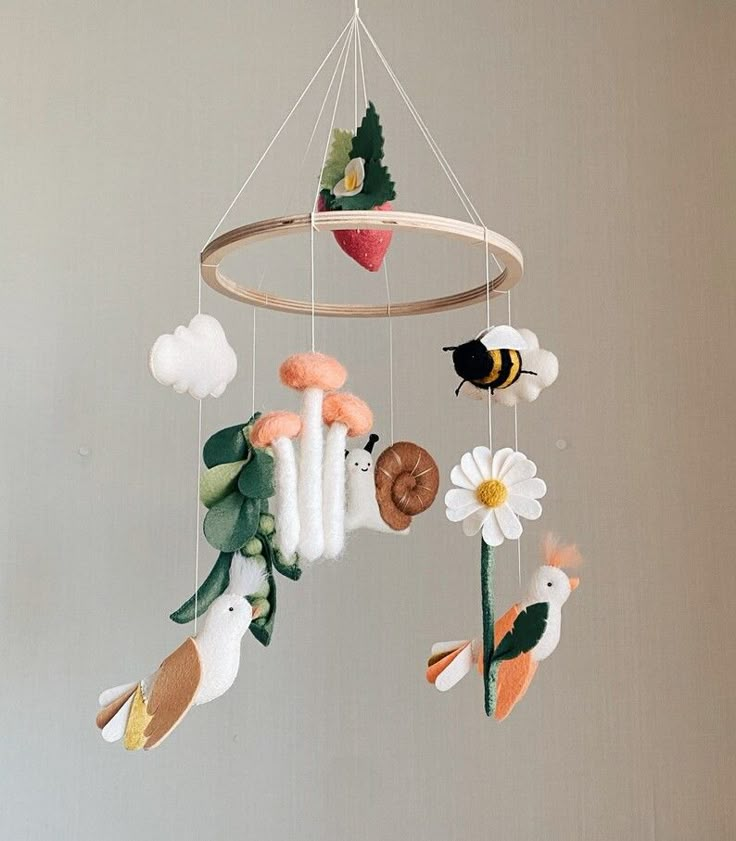 a mobile with animals and flowers hanging from it