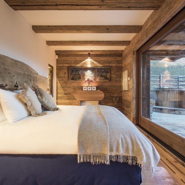 a large bed in a room with wooden walls