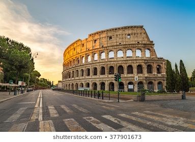 the roman colossion in rome, italy at sunset with sun shining on it